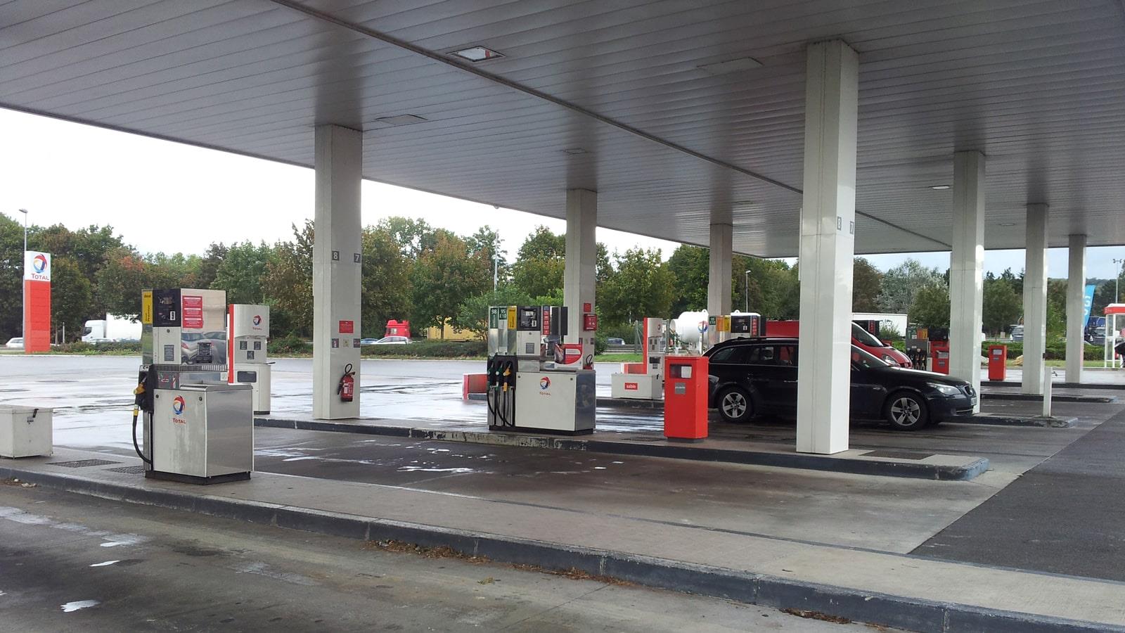 Car next to petrol pump at French petrol station Total