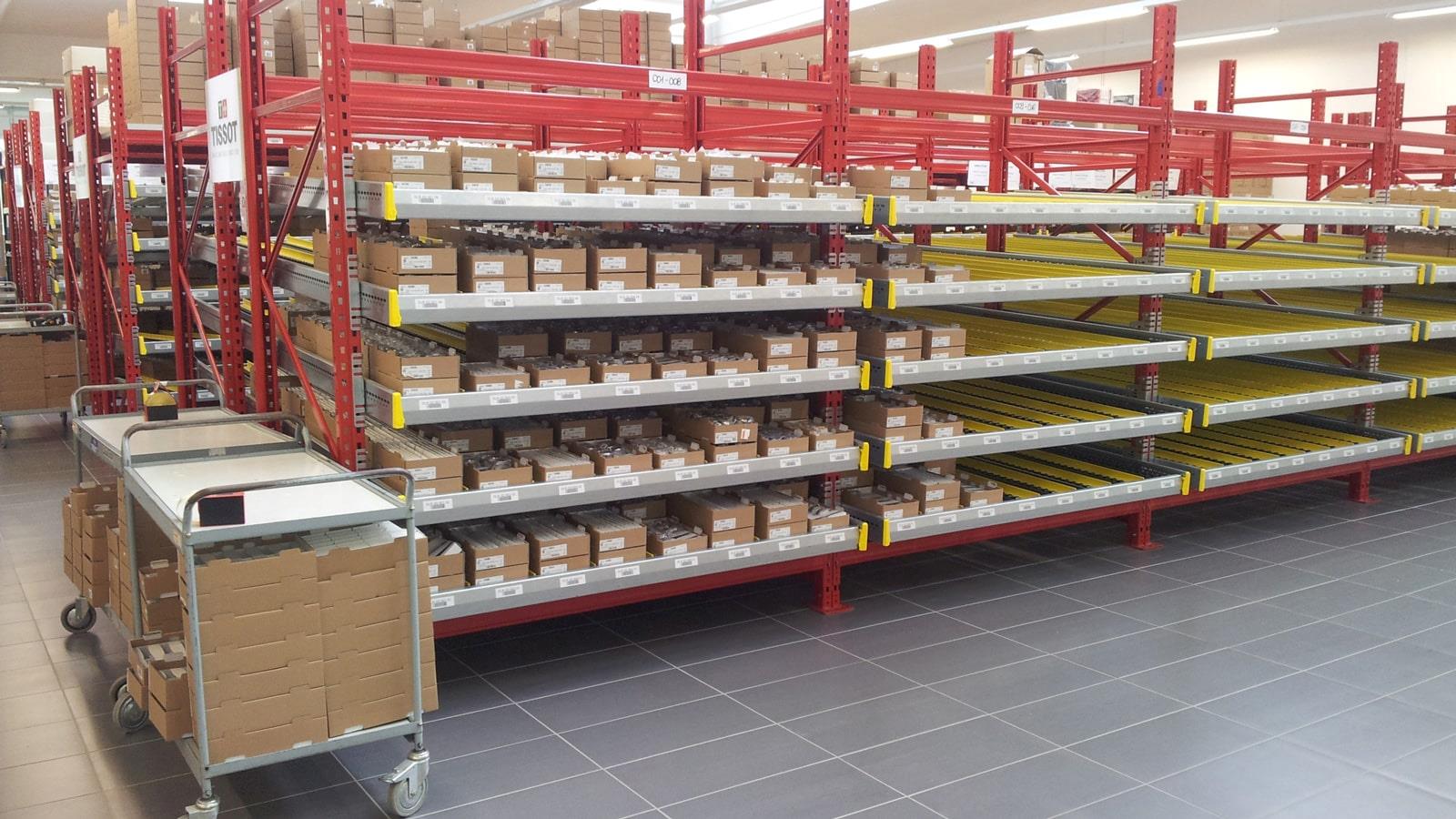 Cardboard boxes with Tissot watches on shelves in the warehouse 