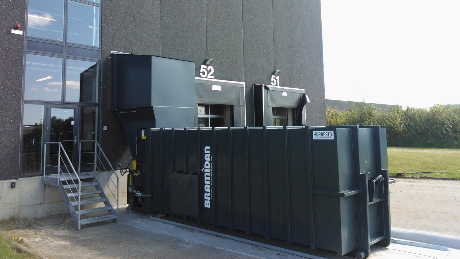 Bramidan compactor with filling through wall standing outside Prime Cargo building