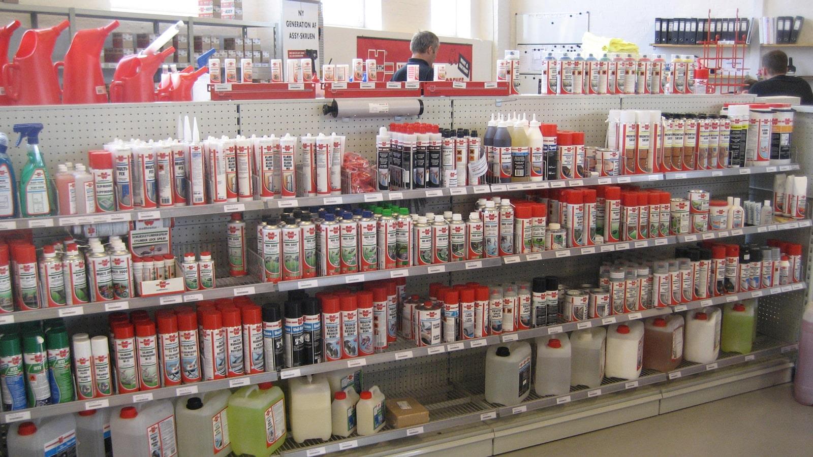 Spray cans and plastic containers on shelves at Würth